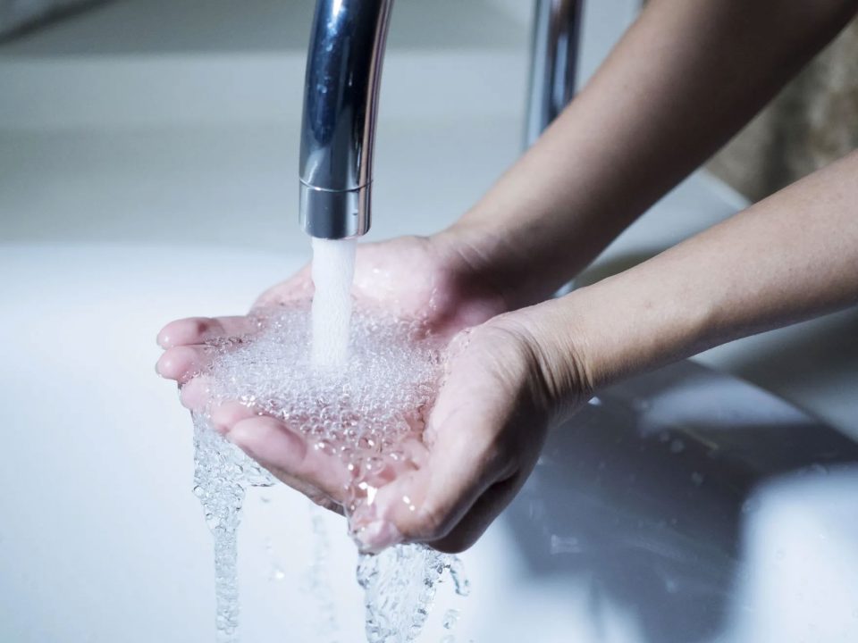 hands being washed with water